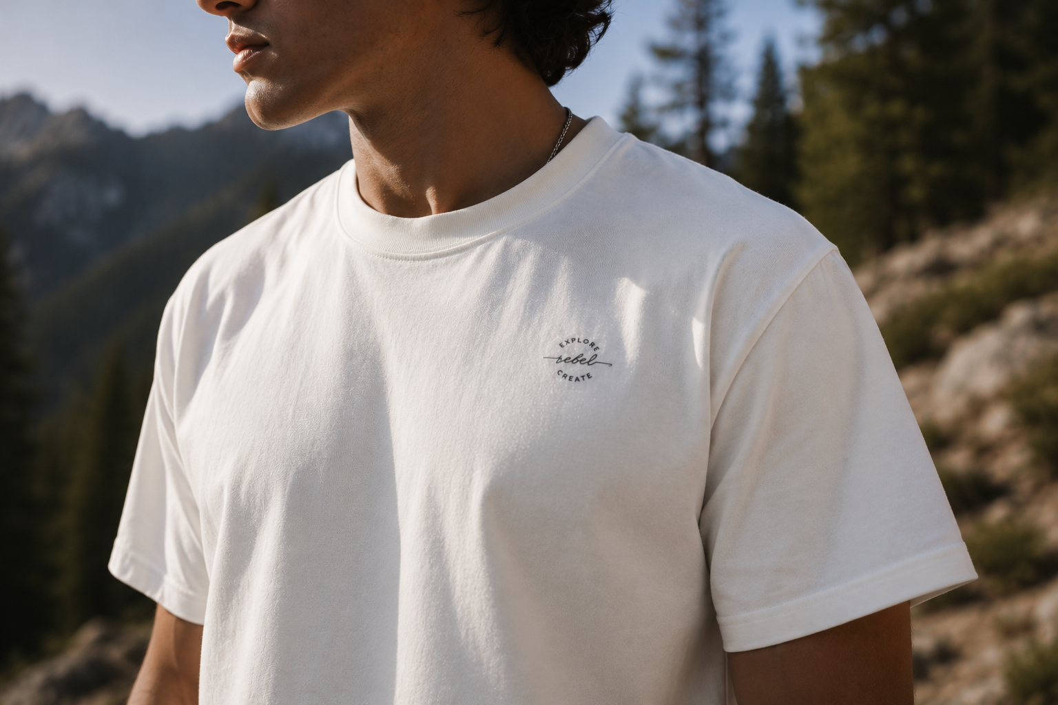 White Founder’s Edition tee with small Explore Rebel Create chest mark